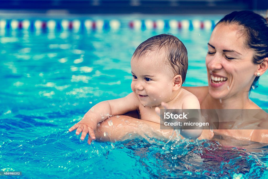 Baby boy with his mother in the pool Cute baby boy enjoying with his mother in the pool. Baby - Human Age Stock Photo