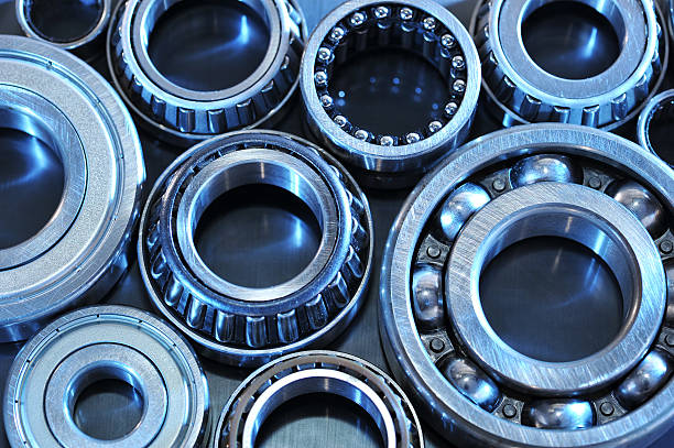 ball-bearings closeup view of several ball-bearings in blue light gyration stock pictures, royalty-free photos & images