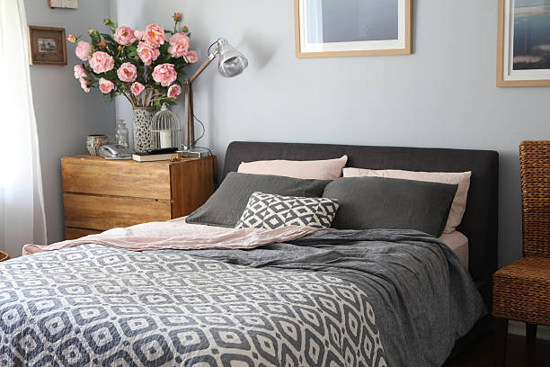 Domestic Bedroom on trend bedroom in greys and pinks bed sheets stock pictures, royalty-free photos & images