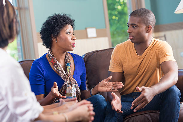 istock African American woman leading discussion during support group meeting 488980989
