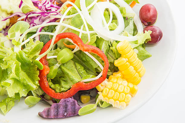 istock Fresh healthy salad dish on white background 488986400