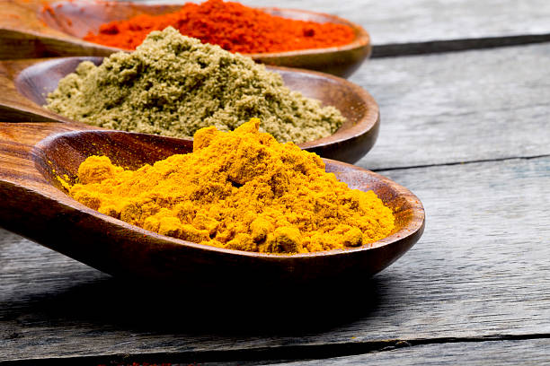istock Various colorful spices in wooden spoons on table 488988202