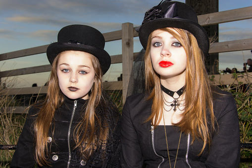 Whitby, UK - November 1, 2014: Whitby Goth Weekend, often abbreviated to WGW or simply referred to by attendees as Whitby, is a twice-yearly music festival for goths, in Whitby, North Yorkshire, England, organised by Jo Hampshire who runs Top Mum Promotions. Goths in full dress at St Mary's Church