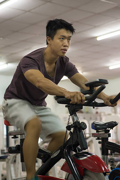 istock The young man riding an exercise bike 488990026