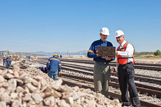 Engineer and Businessman at Railroad Construction stock photo