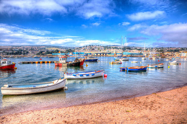 Boats on Teign river Teignmouth Devon with bright colourful blue sky English artistic coastal scene in HDR