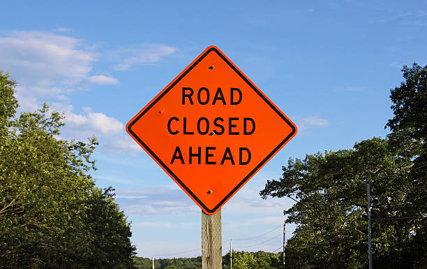 istock Bright orange road closed ahead sign 488998319