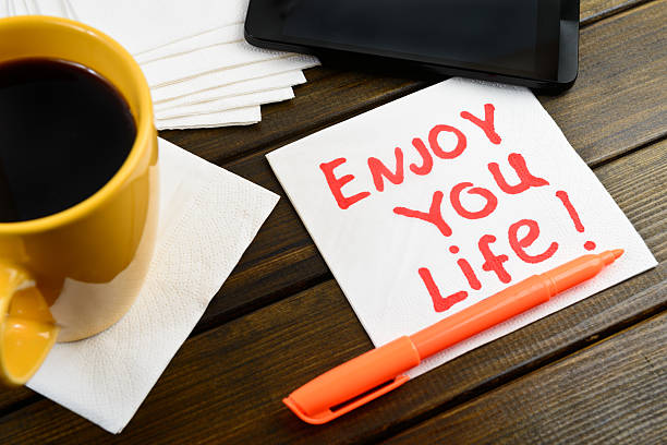 istock Enjoy your life writing on white napkin 488998972