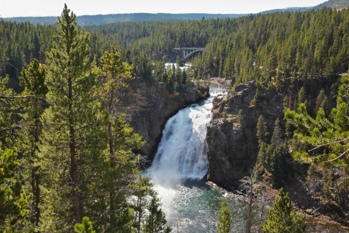 Beautiful falls on rough northern river among an autumn wood