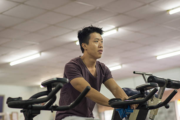 istock Muscle man exercising in the gym 488999322