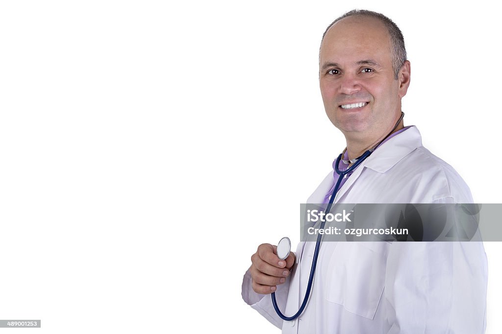 Middle Aged Practitioner Doctor looking at you Trustfully Middle age male practitioner doctor looking at you trustfully with a confident smile and holding his stethoscope Adult Stock Photo