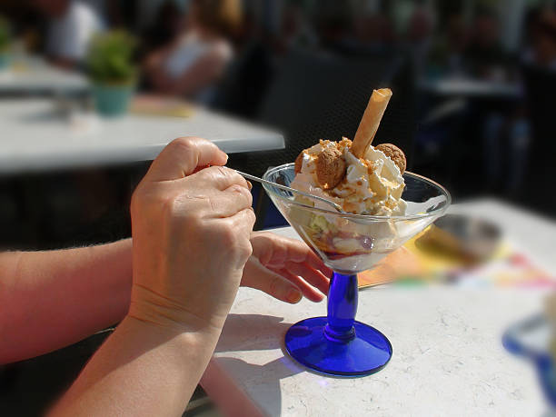 Eating Of Sweet Italian Ice Cream In A Restaurant