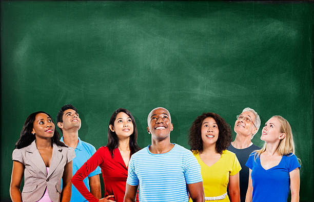 istock Group of Multiethnic Students Looking Up with Blackboard 489001481