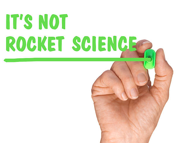 istock Hand with Pen Writing its not rocket science quote 489002457