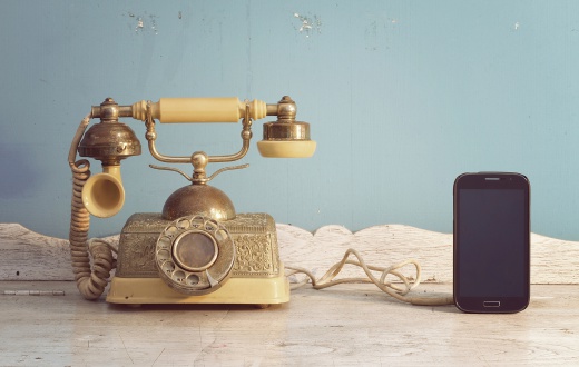 luxury vintage telephone and smartphone on white wooden classic table, formerly and modern Connect.