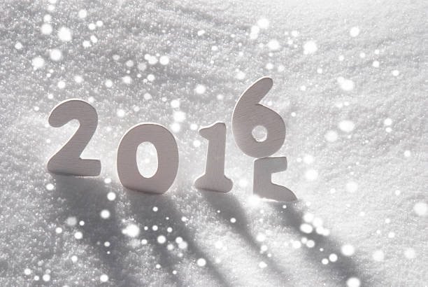White Wooden Letters Building English Text 2016 2015. Snow And Snowy Scenery With Snowfalkes. Christmas Atmosphere. Christmas Background Or Christmas Card For Seasons Greetings