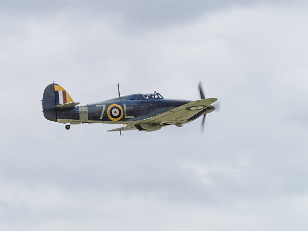 Vintage Hawker Hurricane Yeovilton, UK - 11th July 2015: Vintage Hawker Hurricane flying at Yeovilton Air Day. falco columbarius stock pictures, royalty-free photos & images
