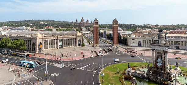 Barcelona, Spain - July 8, 2015: View top to The Placa d'Espanya in Barcelona. Placa d'Espanya fountain and the Fira de Barcelona conference center and Venetian Towers in the foreground, and the MNAC or National Palace and Torre Calatrava in the background, Barcelona, Spain.