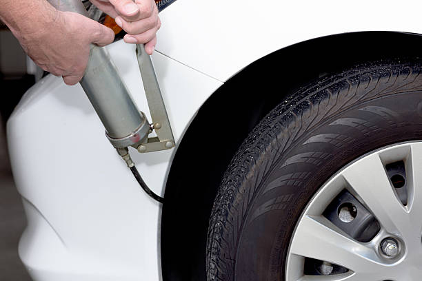 istock Grease gun used to lubricate a car 489005440