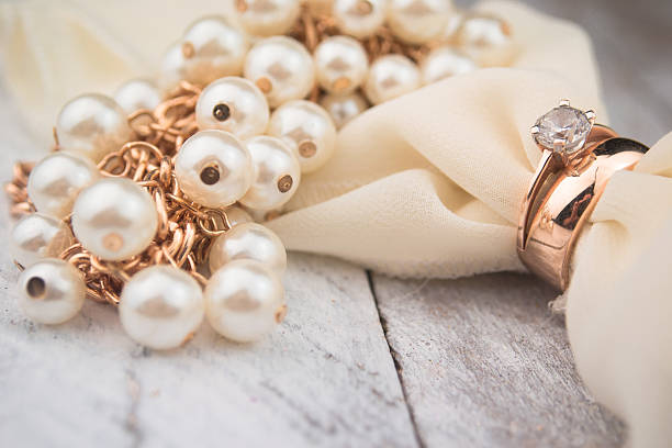 istock Golden wedding rings on white wood background 489005918
