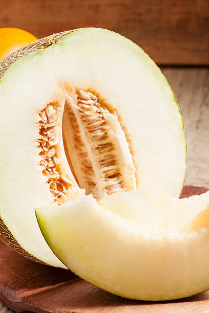 istock cut melon and slices on a wooden table 489007696