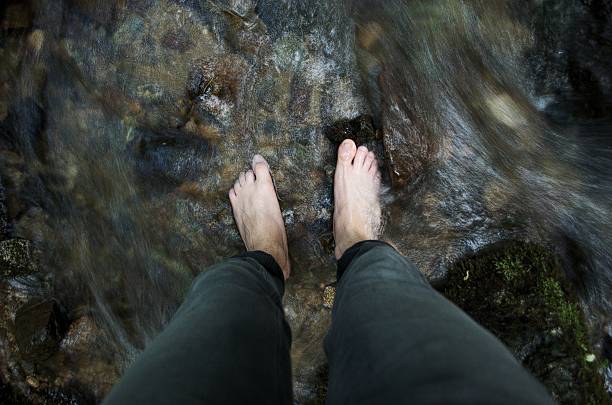 istock Feet in a creek's flowing water 489008604
