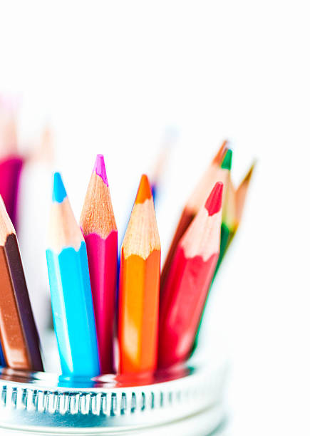 Artist's supplies: Watercolor pencils in glass jar with copyspace