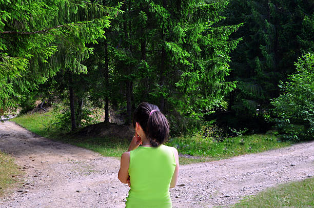 ragazza con una scelta vicino al bivio - footpath field nature contemplation foto e immagini stock