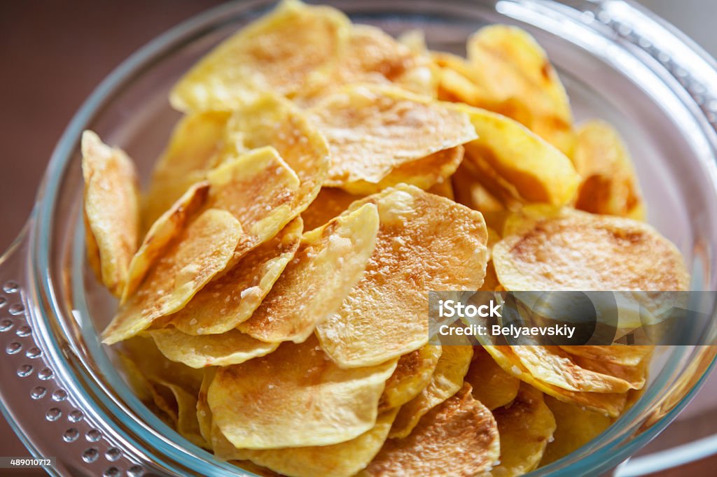 Potato Chips Delicious homemade potato chips in a glass bowl 2015 Stock Photo