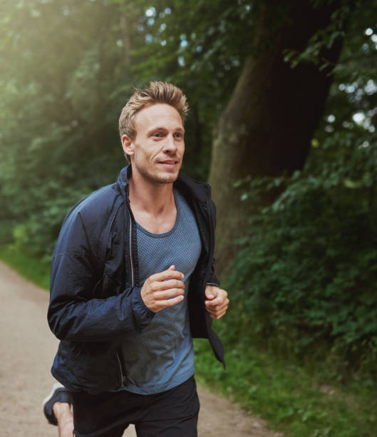 istock Physical Fit Man Running at the Park Alone 489010986
