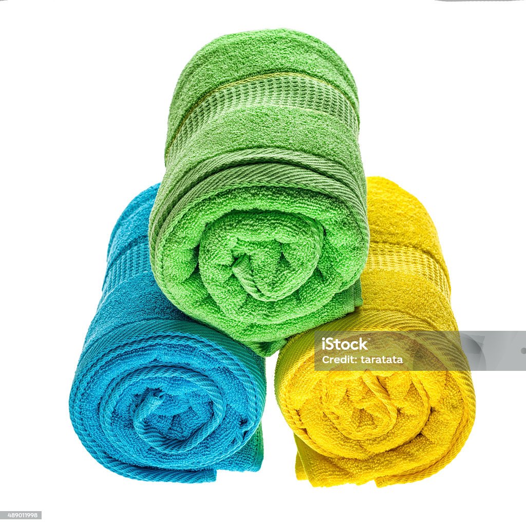 Towels pile isolated Green, blue and yellow towels pile isolated on white background. 2015 Stock Photo