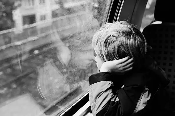 Photo of 7 years old boy sitting in the train