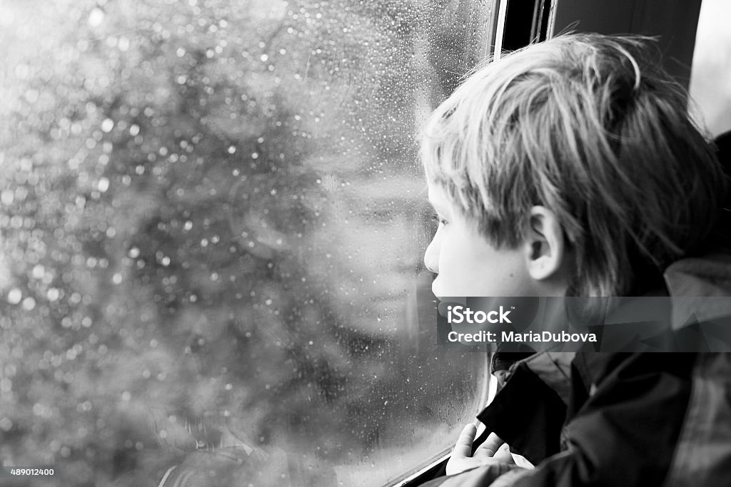 7 years old boy sitting in the train 7 years old boy sitting in the train and looking to the rain 2015 Stock Photo