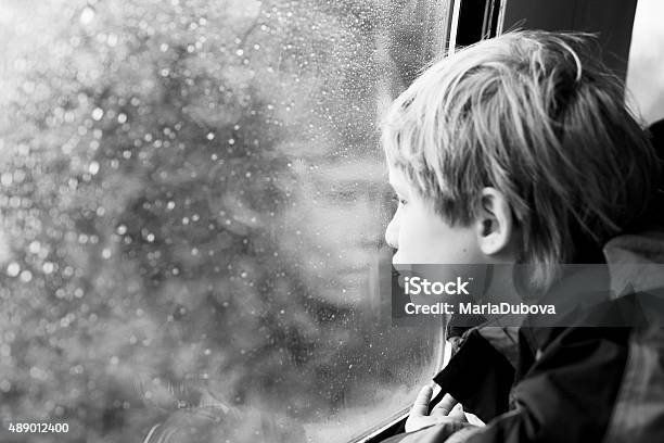7 Years Old Boy Sitting In The Train Stock Photo - Download Image Now - 2015, Autism, Autumn