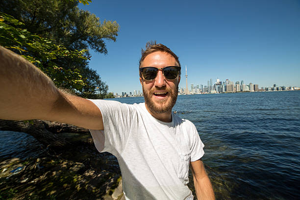 istock Cheerful young man taking selfie in Toronto 489012410