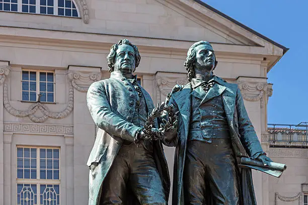 Monument of the famous German poets Goethe and Schiller in front of the German National Theatre in Weimar (Thuringia, Germany).