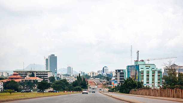 African city skyline. Abuja, Nigeria. Abuja, Nigeria - September 4, 2015: Traffic in the streets of downtown area in Nigeria's capital city. abuja stock pictures, royalty-free photos & images