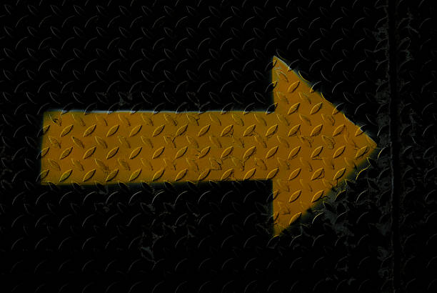 istock yellow arrow on steel plate 489035598