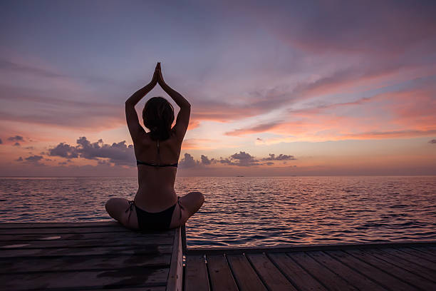 istock Caucasian woman practicing yoga at seashore 489036068