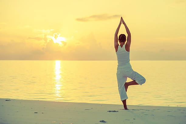 istock Caucasian woman practicing yoga at seashore 489038658