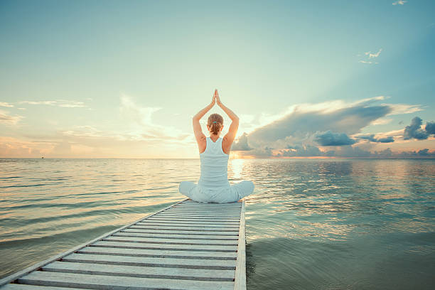 istock Caucasian woman practicing yoga at seashore 489039166