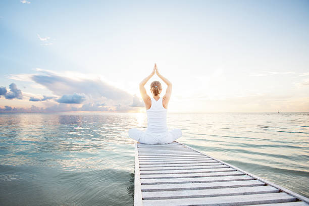istock Caucasian woman practicing yoga at seashore 489039174