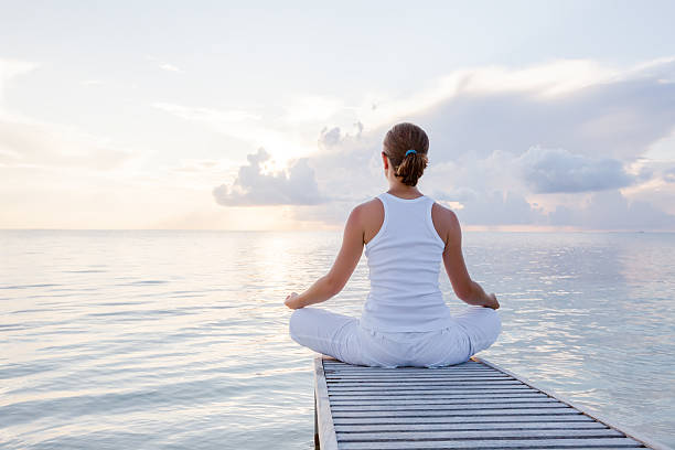 istock Caucasian woman practicing yoga at seashore 489039222