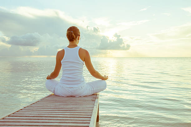 istock Caucasian woman practicing yoga at seashore 489039228