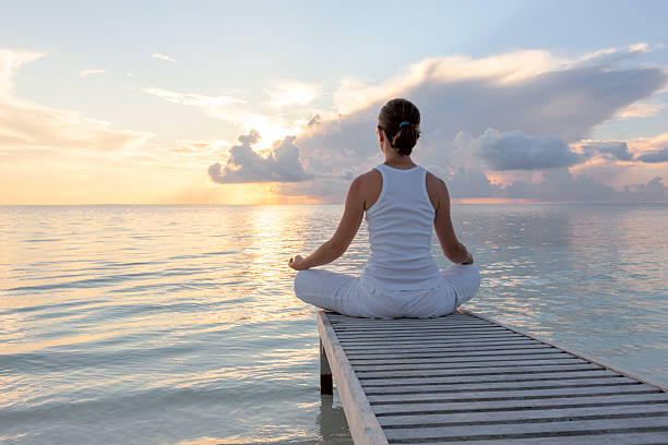 istock Caucasian woman practicing yoga at seashore 489039238