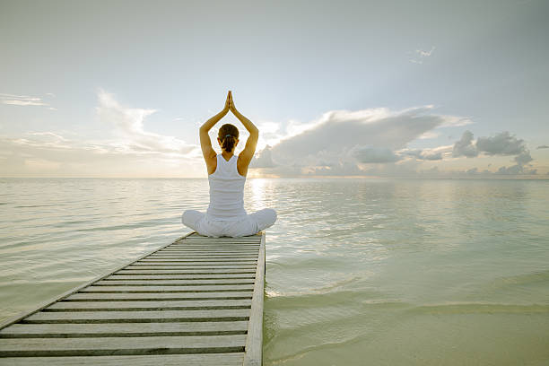 istock Caucasian woman practicing yoga at seashore 489039246