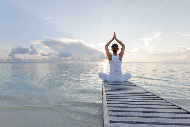 istock Caucasian woman practicing yoga at seashore 489039256