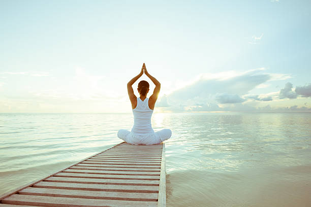 istock Caucasian woman practicing yoga at seashore 489039260