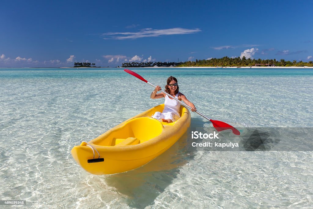 Young caucasian woman kayaking in sea at Maldives 2015 Stock Photo