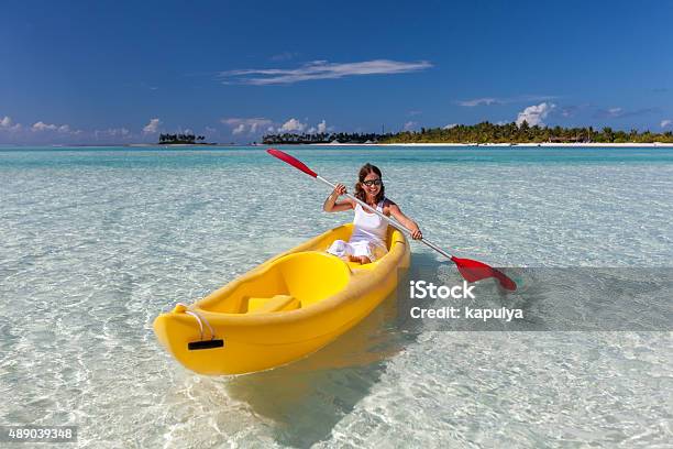 Young Caucasian Woman Kayaking In Sea At Maldives Stock Photo - Download Image Now - 2015, Activity, Adult